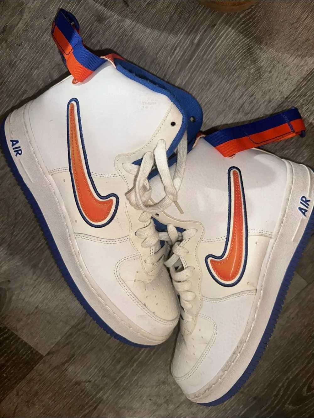Nike White High-Top Sneakers with Orange Swoosh and Blue Accents